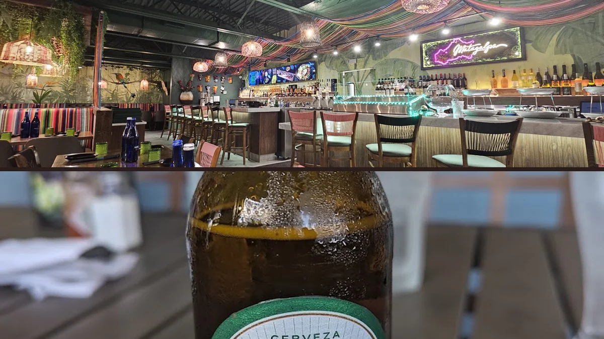 Warm restaurant interior with tables and wall decor.